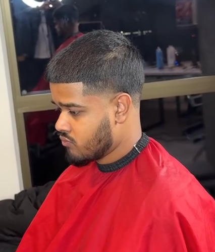 Low fade with a shaped full beard by AB Fadez