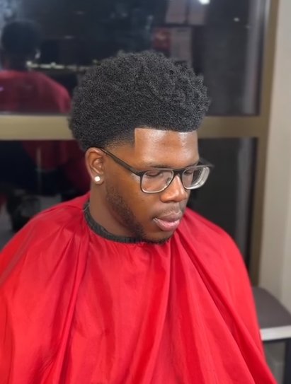 Afro with a straight lineup and tapered sides by AB Fadez