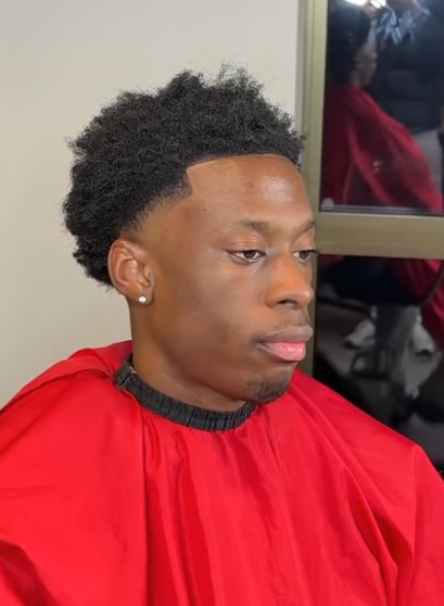Textured afro with a blended fade on the sides by AB Fadez